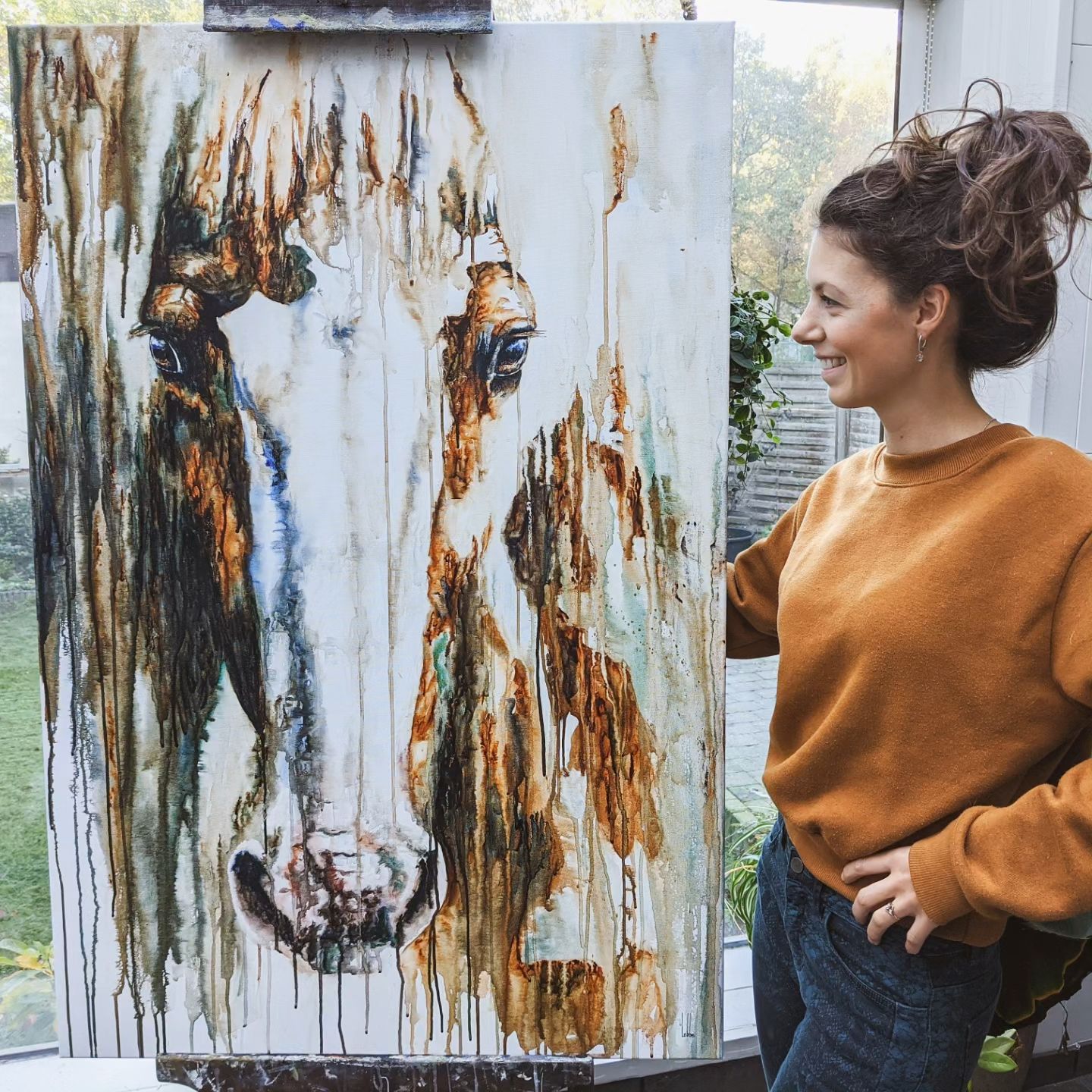 Commission of James, Marjo Lebbe beside her large horse portrait on the easel