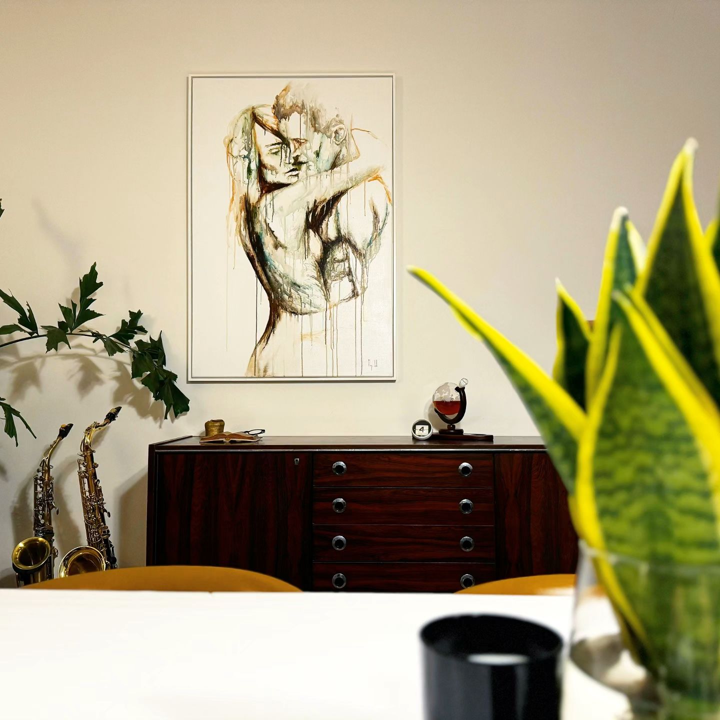 Resonance at its new home, framed figurative watercolour above a wooden sideboard