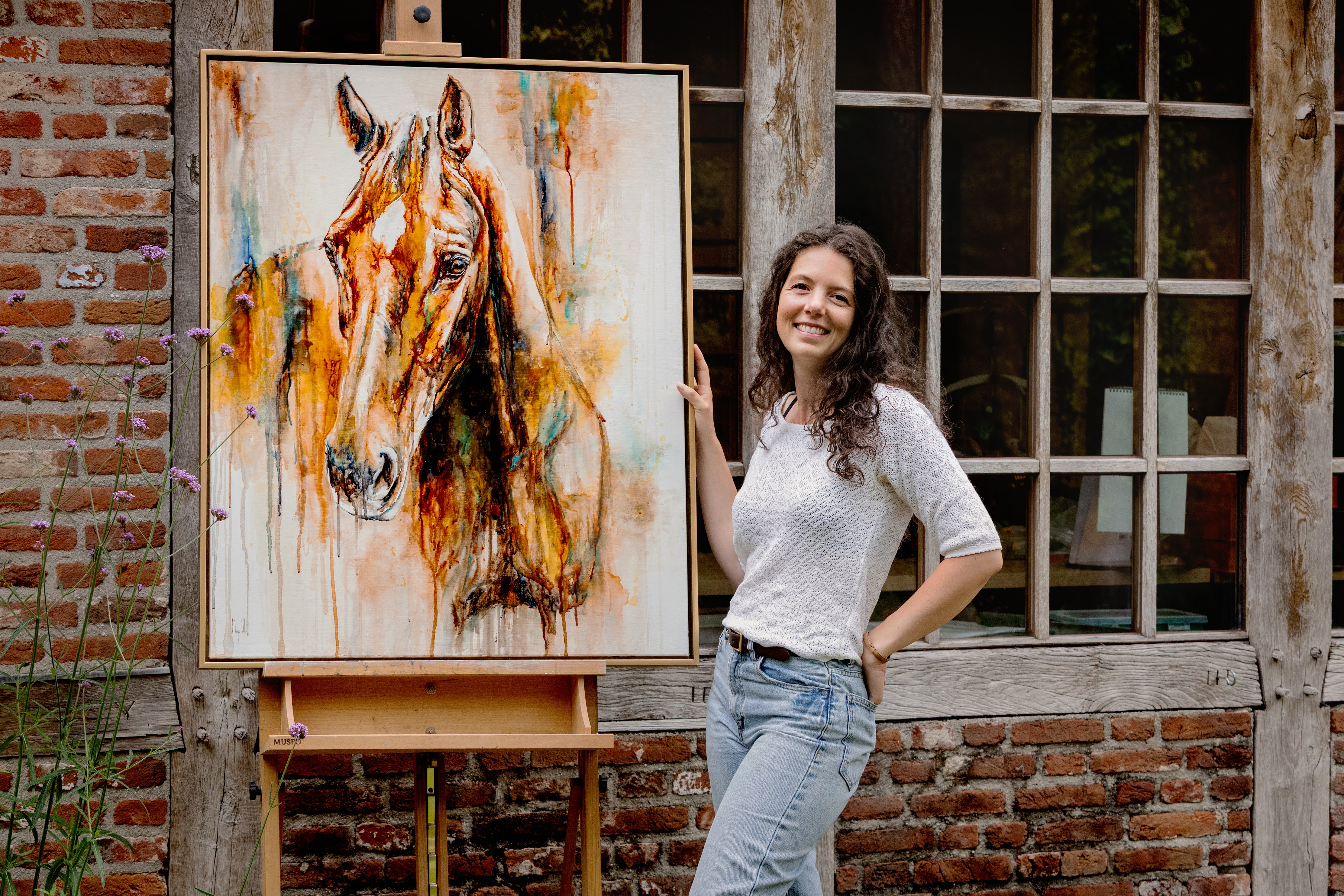 Marjo Lebbe beside her equine watercolour painting