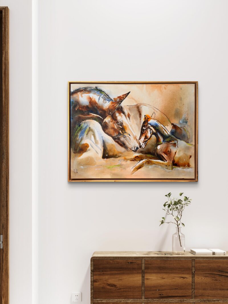 Healing Birth on a white wall above a wooden console with a small plant