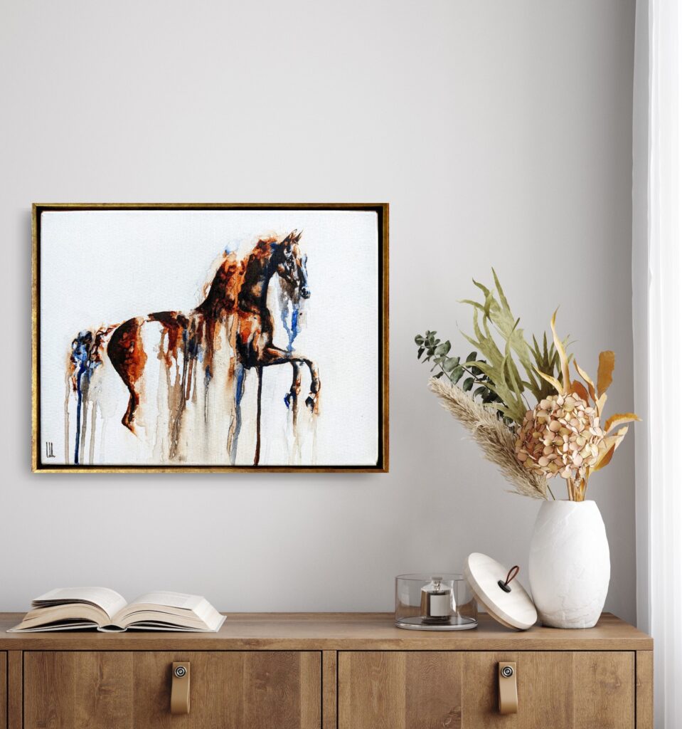 A framed horse painting above a sideboard, shown for scale