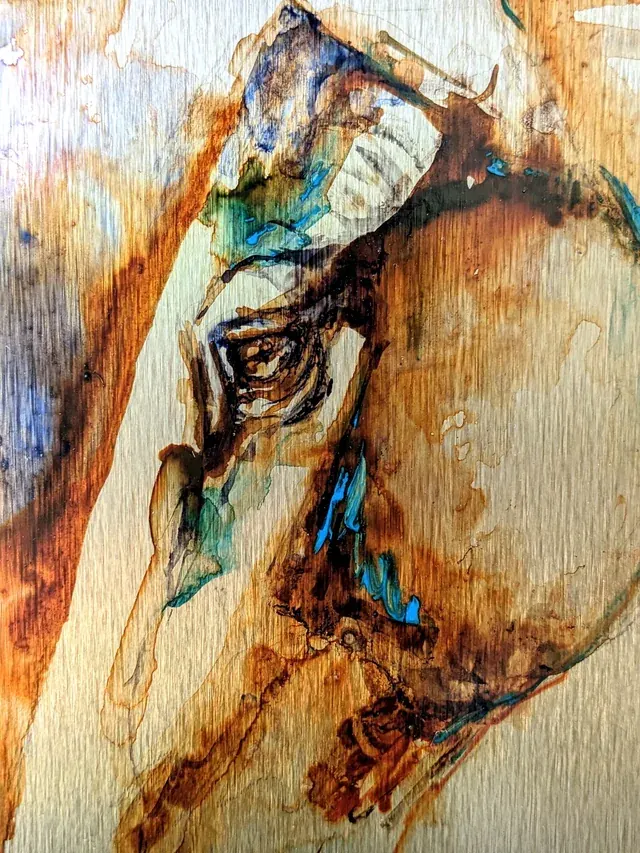 Detail of Anima Ferox: rust and black ink pooling over the brushed metal grain