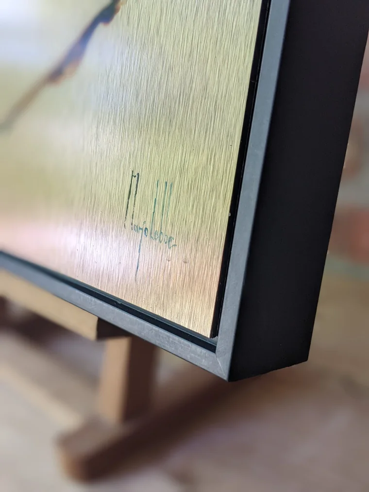 The black frame of Anima Ferox seen from the edge, standing on an easel