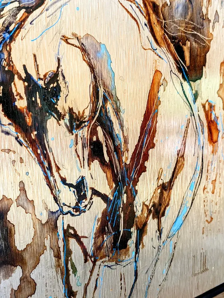 Detail of Anima Ferox: ink running down the brushed metal