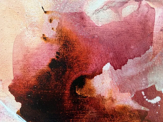 Detail of Athena: a deep crimson ink bloom spreading over the pale linen