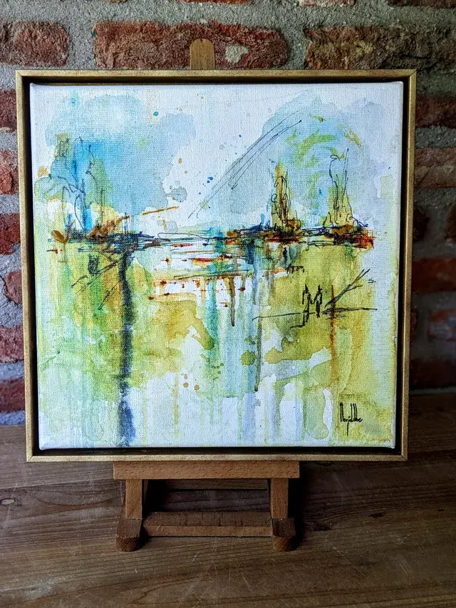 Aurora standing framed on a small wooden easel against a brick wall in Marjo Lebbe's studio