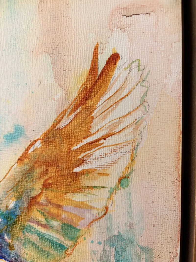 Detail of Bird Soul: the kingfisher's outstretched wing in gold ochre and white over teal washes
