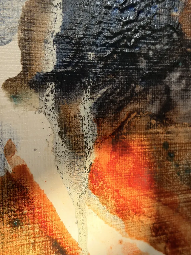 Detail of Bronze: deep patina blacks split open by a bloom of fiery orange, the linen weave showing through
