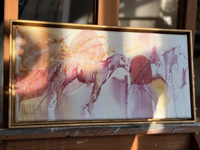 The wide work on the easel in Marjo's studio, late sunlight raking across the gold frame
