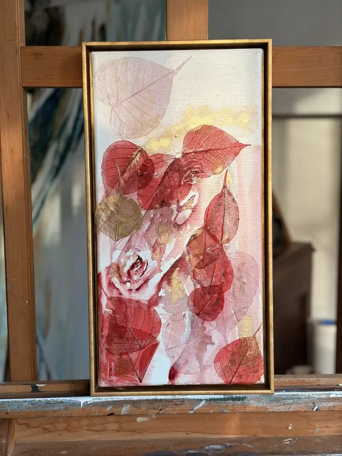 The upright work standing on the studio easel in front of an unfinished canvas