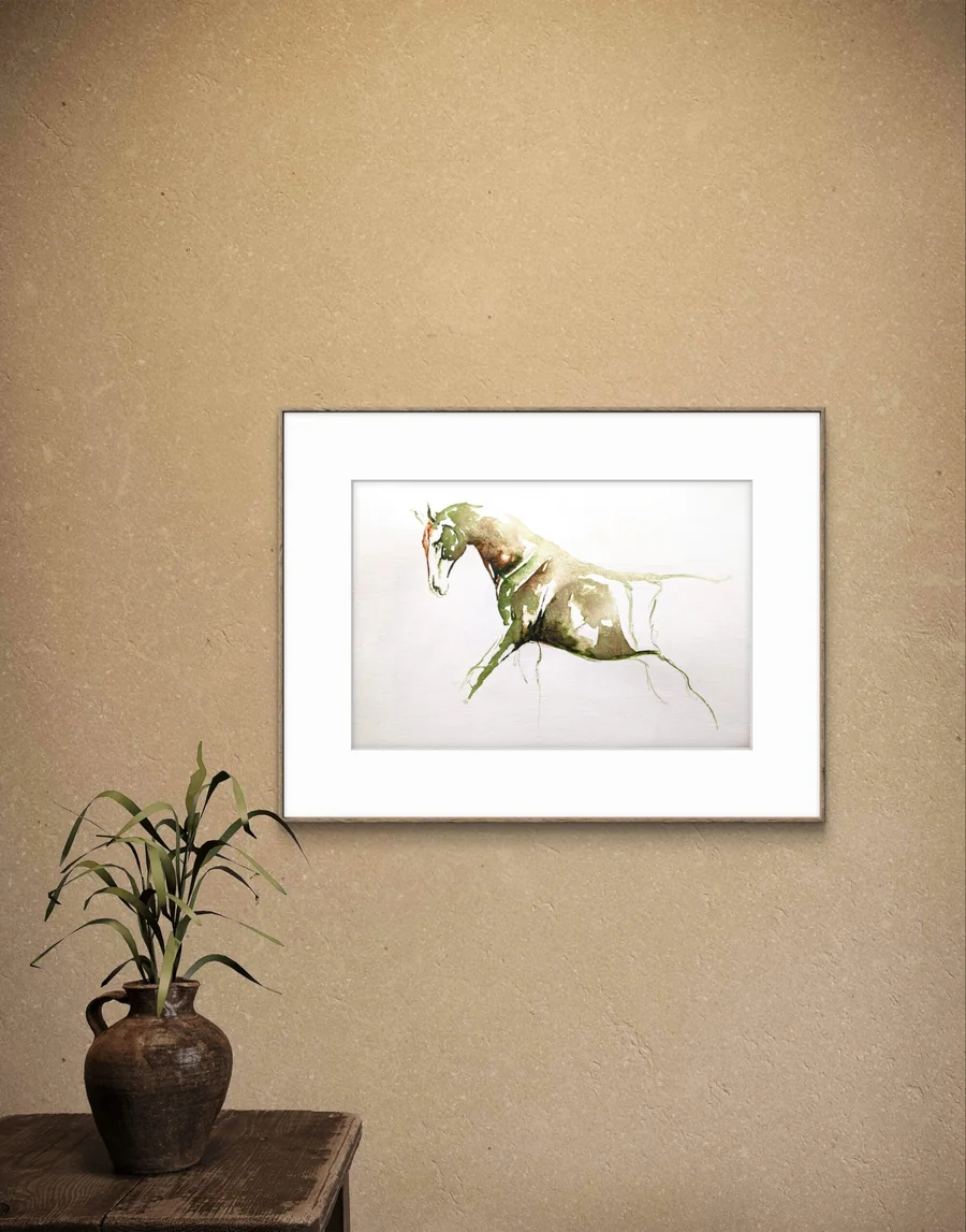 A framed Praise watercolour on a warm wall above a table with a plant