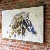 Horse painting with real leaves against brick wall