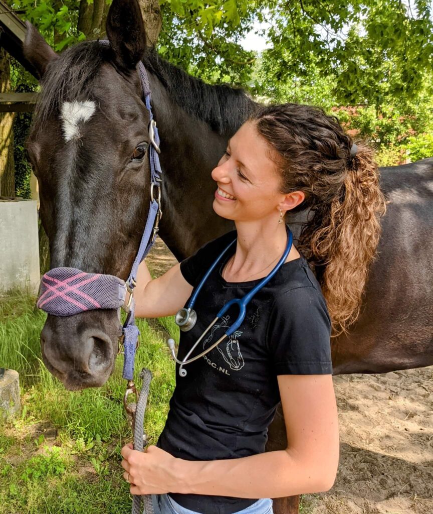 Marjo Lebbe as an equine veterinarian with her black horse